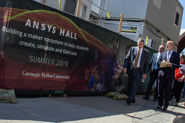 People walking in front of ANSYS Hall Sign