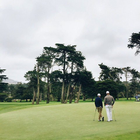 2 people standing on golf course