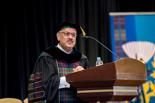 President Jahanian speaking at podium at graduation