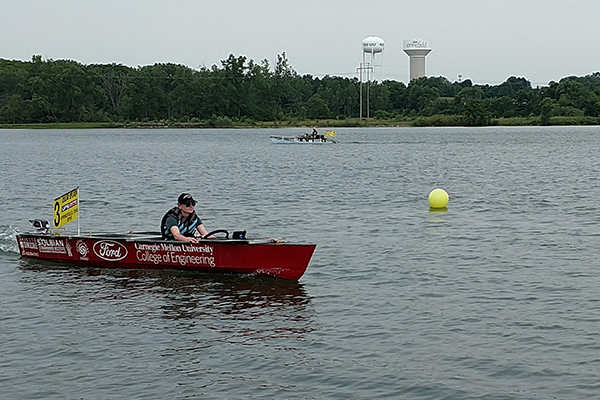 Student in boat in water, racing