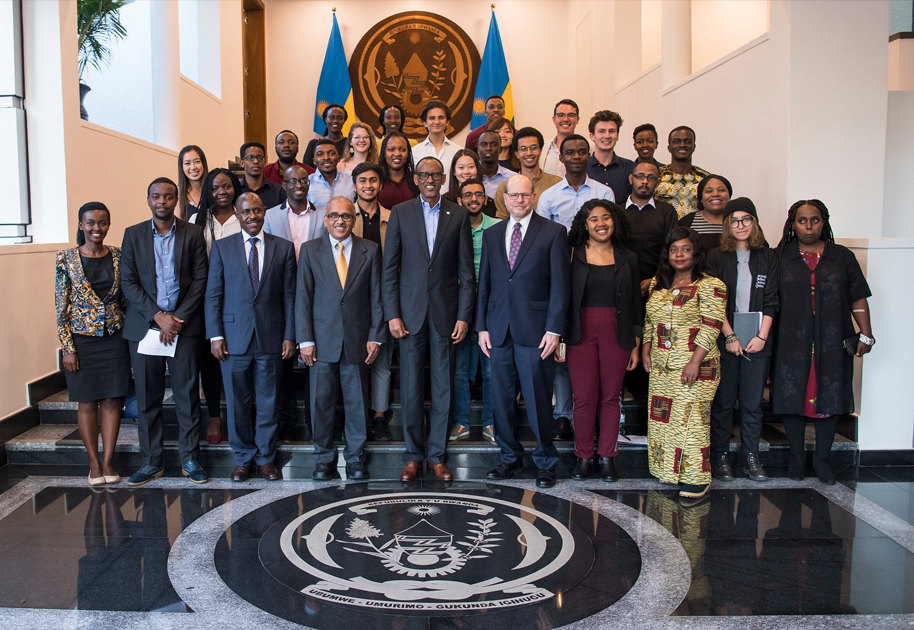 President Kagame posing with students for a group shot.