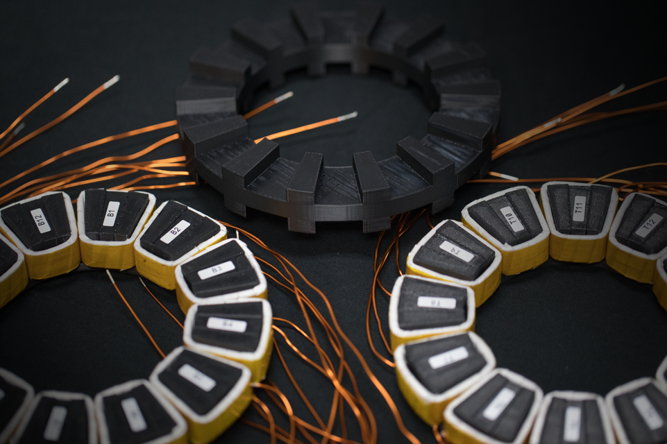 Circular motors on a black background with copper wires